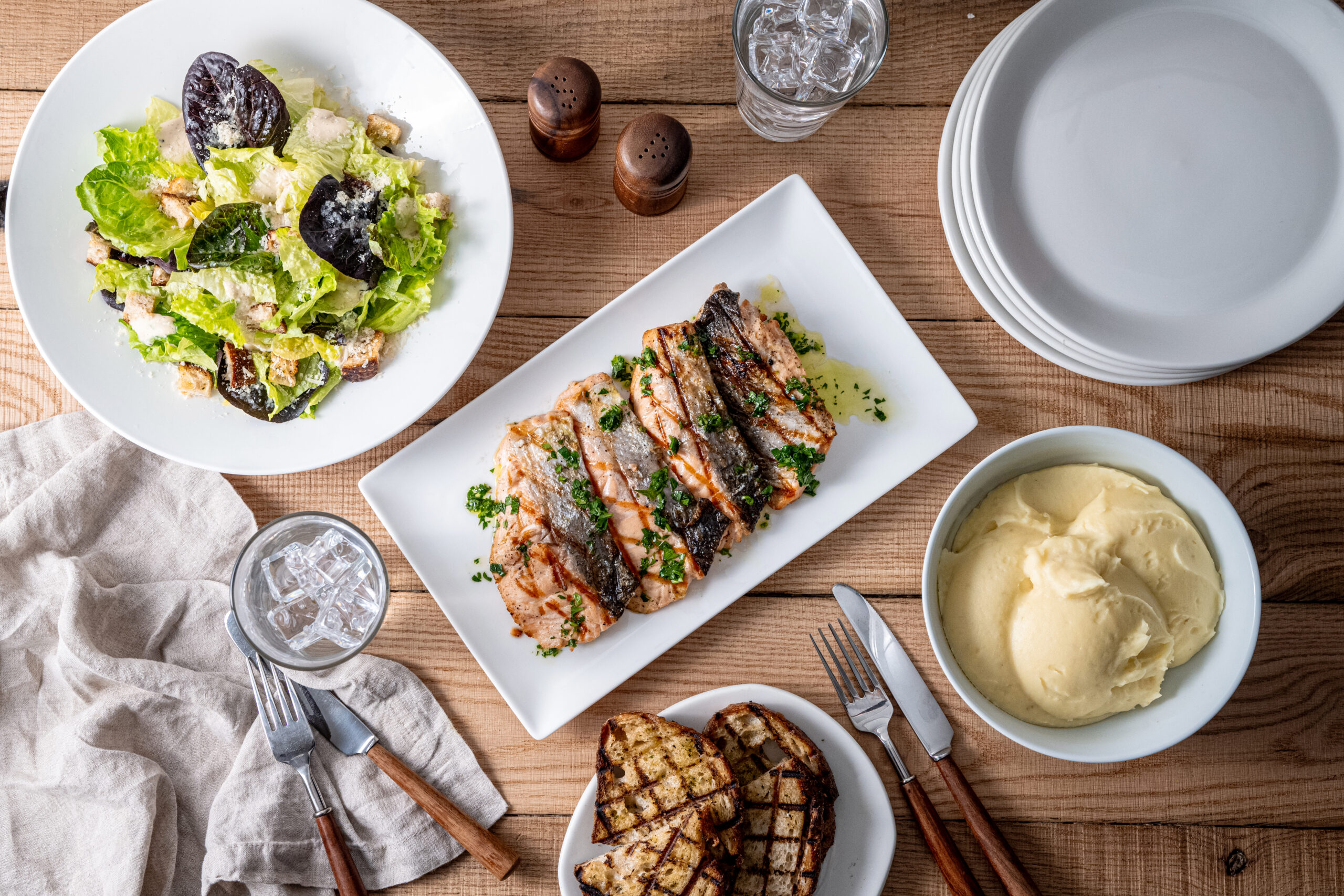 Tender Greens entrees and side dishes displayed on a table