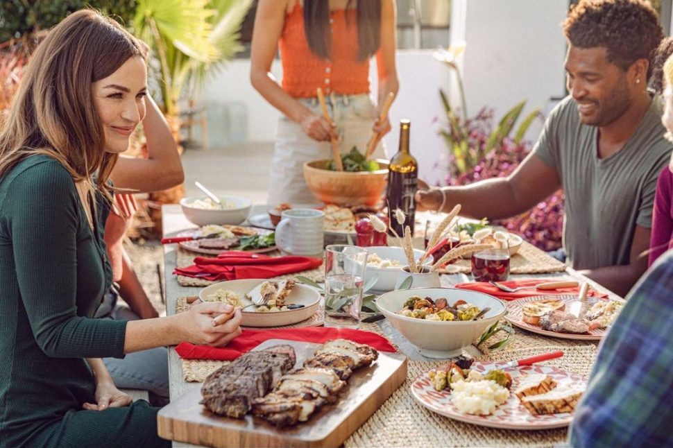 People sitting at a table enjoying a Tender Greens meal together